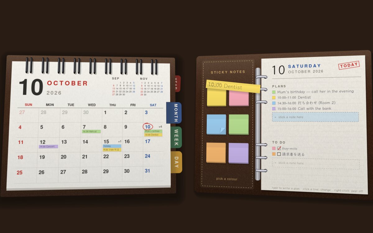 The desk calendar at October, beside its binder of sticky notes
